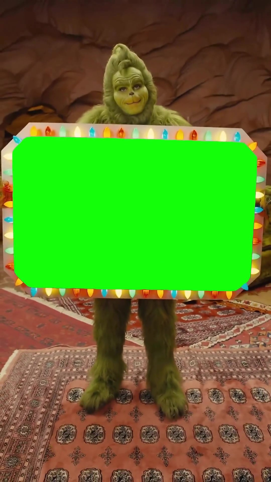 Grinch holding a sign green screen